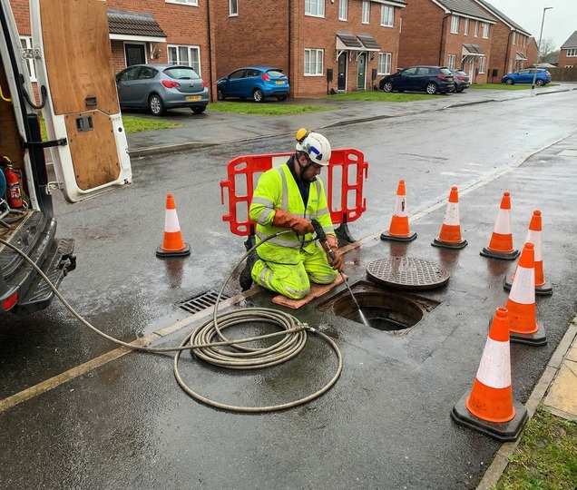 Drainage specialist operating high pressure water jetting equipment for planned maintenance.